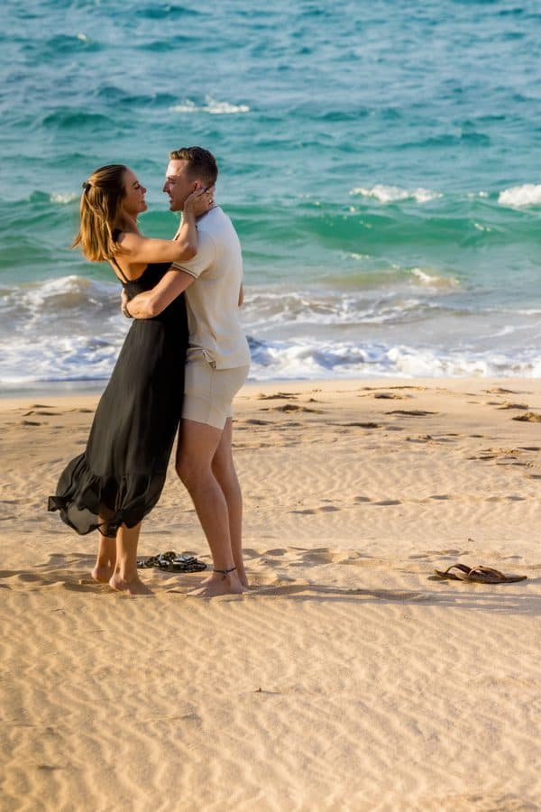 Kai and Chase embracing on the beach